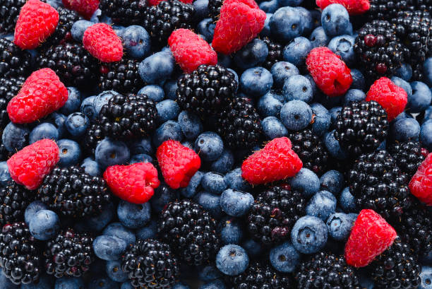 istock Blackberry, raspberry, blueberry background.  Top view. 1202216118