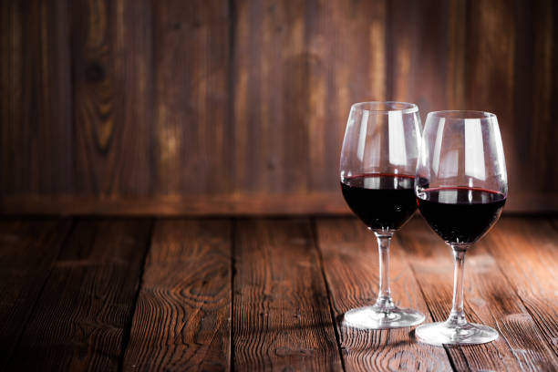 istock Red wine glasses on wood 1202217262