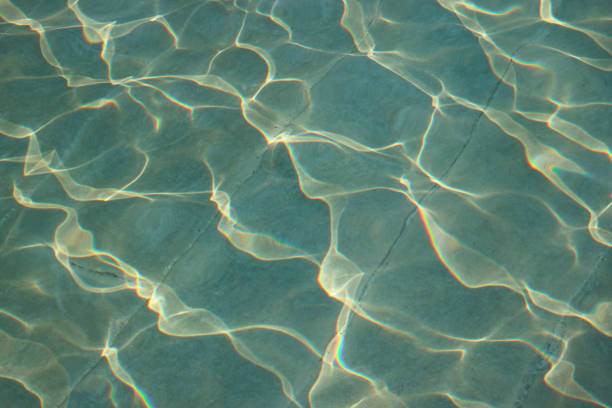 istock Beautiful water surface reflecting with the sunlight for background or banner 1202217602