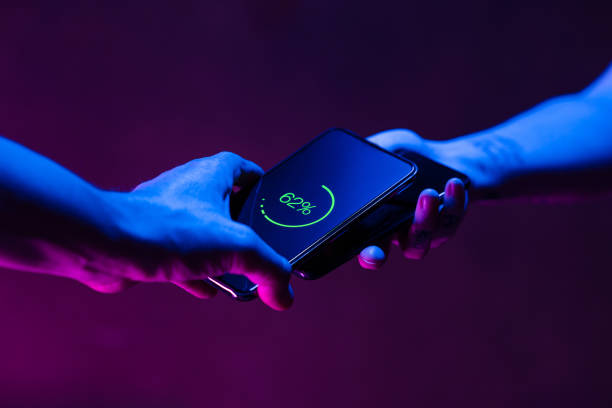 istock Sharing power with wireless battery charging between two smart phones 1202220342