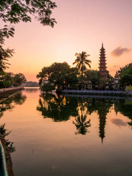 View of the Tran Quoc Pagoda and the West Lake at sunset. In Hanoi, Vietnam