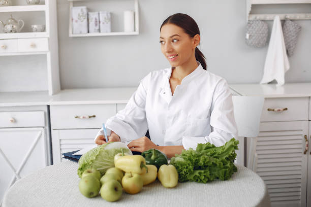 istock Beautiful doctor in a kitchen with a vegetables 1202220438