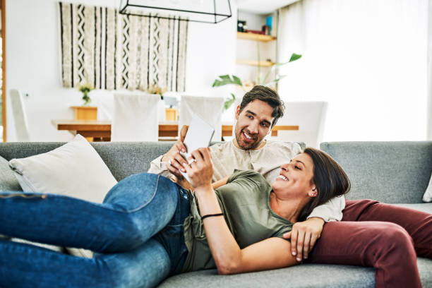 istock Couple looking at digital tablet in living room 1202220694