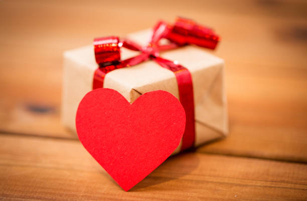 istock close up of gift box and heart shaped note on wood 1202222366