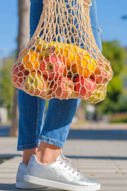 istock A young modern woman is standing with mesh reusable net bag 1202223098