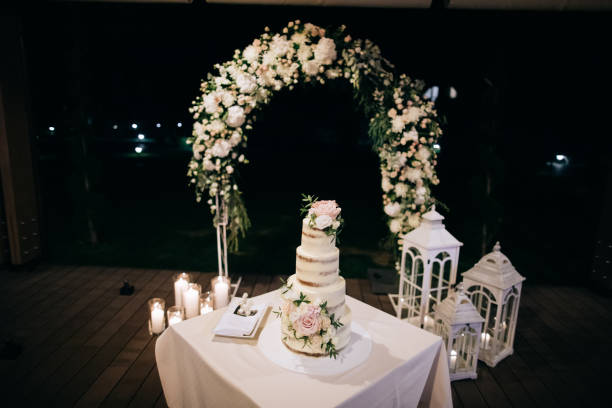 istock wedding cake and beautiful wedding arch in night 1202223322