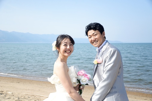 Happy bride and groom on the beach,Japan