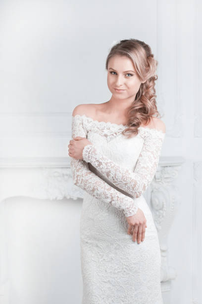 istock smiling happy bride trying on wedding dress 1202224638