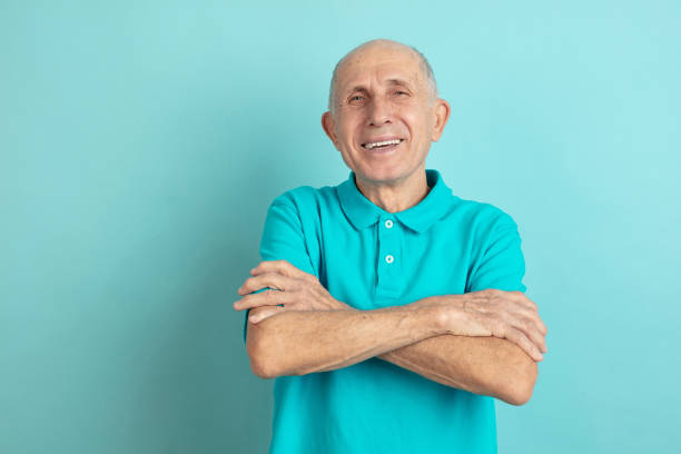 istock Caucasian senior man's portrait isolated on blue studio background 1202225342