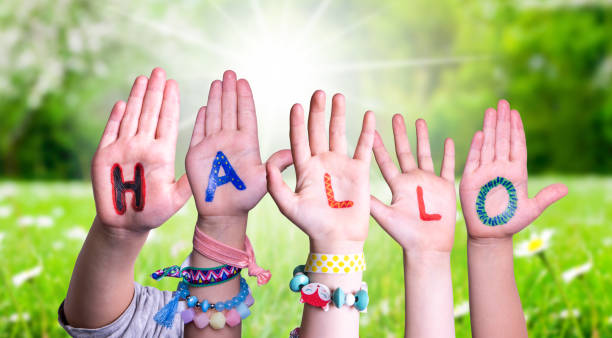 istock Children Hands Building Word Hallo Means Hello, Grass Meadow 1202225421