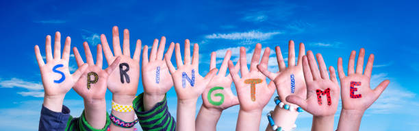 istock Children Hands Building Word Springtime, Blue Sky 1202226236