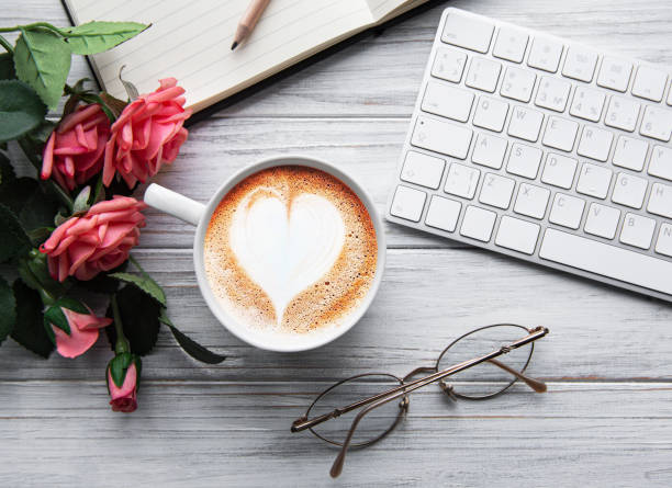 A cup of coffee with heart pattern on a table