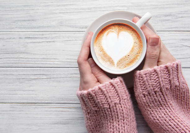 istock Woman holding cup of coffee 1202226507