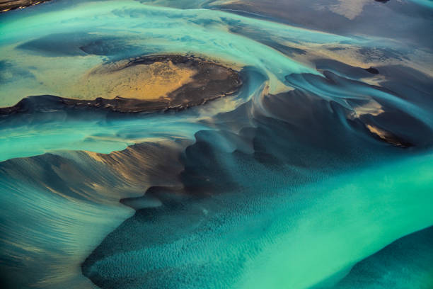 Beautiful emerald-colored glacial rivers of Iceland, taken from a helicopter Helicopter view of wonderful turquoise-colored glacial rivers in Iceland. iceland photos stock pictures, royalty-free photos & images
