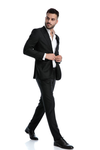 istock businessman walking one way and fixing his jacket 1202231467