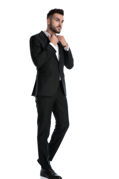 istock businessman walking while fixing his shirt's collar 1202231524