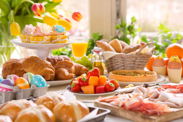 Table with delicatessen ready for Easter brunch Breakfast or brunch table filled with all sorts of delicious delicatessen ready for an Easter meal. easter cake photos stock pictures, royalty-free photos & images