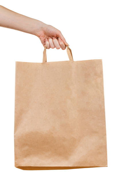 istock Hand holding paper bag on white 1202231779