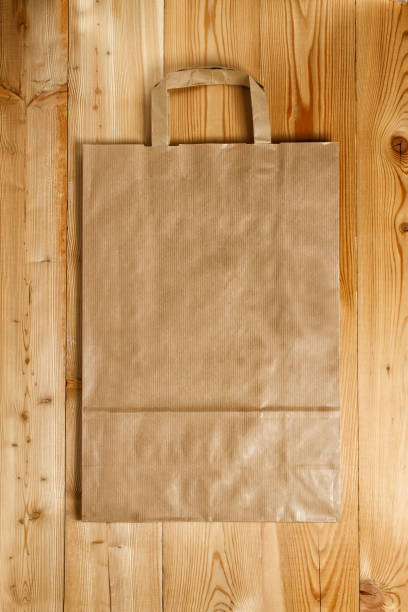 istock Paper bag on a wooden texture 1202231867