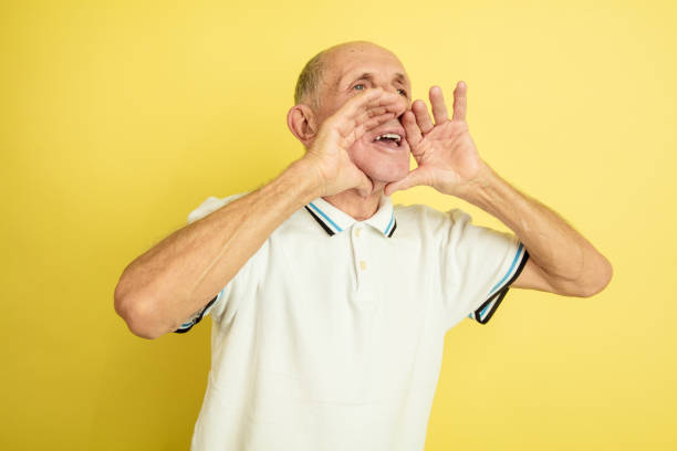 istock Caucasian senior man's portrait isolated on yellow studio background 1202233427