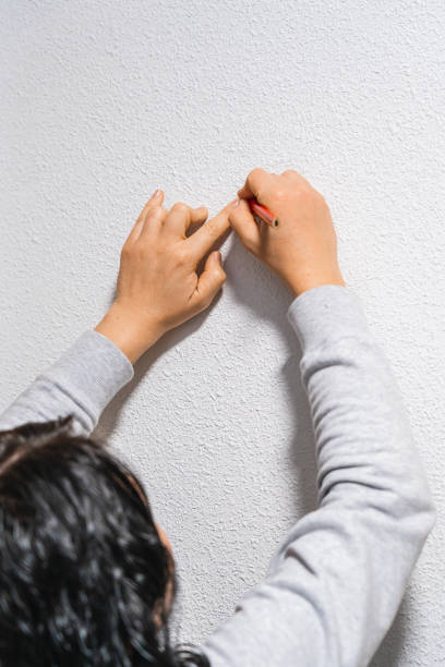 istock A woman marking the white wall 1202233505