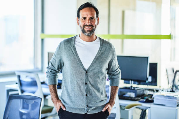 istock Smiling mature businessman standing in office 1202235222