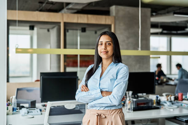 istock Confident young businesswoman standing in office 1202236176