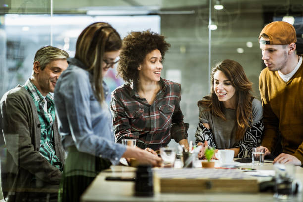 istock Happy creative people talking on a meeting at casual office. 1202236574