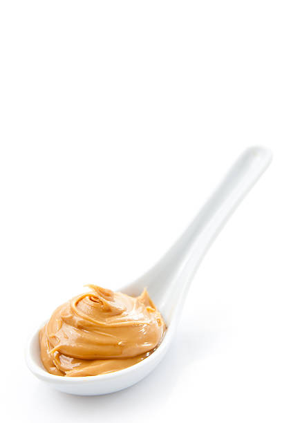 istock A spoon holding a dollop of peanut butter 120223667