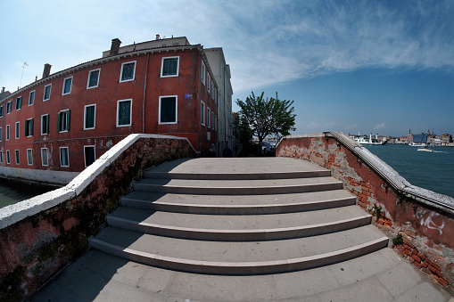 La Giudecca  Island-Venezia- Italy-April 26, 2018: VENEZIA- La Giudecca Island - Fondamenta Sant'Eufemia-  a pedestrian bridge.Views of the Venetian island.
