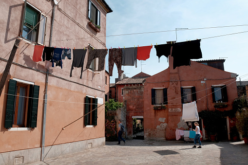 La Giudecca  Island-Venezia- Italy-April 26, 2018: La Giudecca Island -Corte Berlomeni. Laundry hanging between houses, a typical view of the Venetian cityscape.