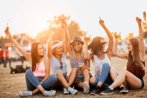 Group of female friends drinking beer and having fun at music festival Group of female friends drinking beer and having fun at music festival 3686 stock pictures, royalty-free photos & images