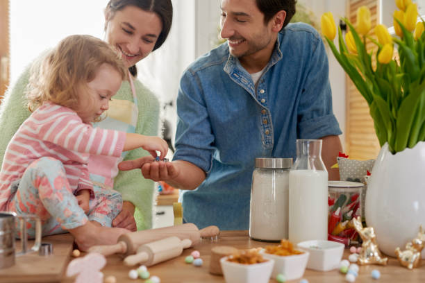 istock Little girl helping parents at the kitchen 1202241044