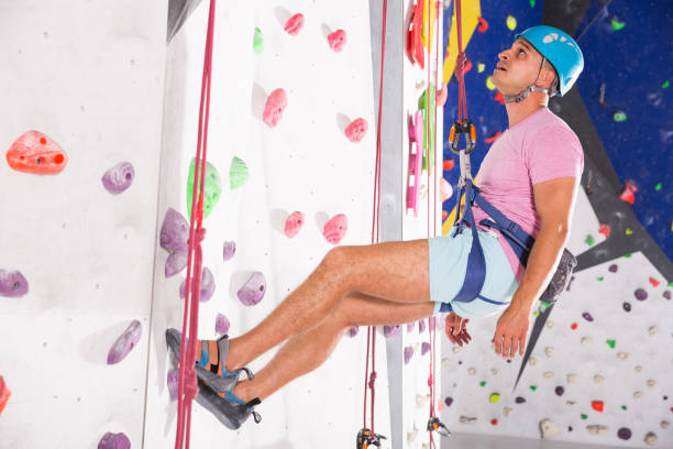 istock Man in climbing outfit training at bouldering gym 1202241213