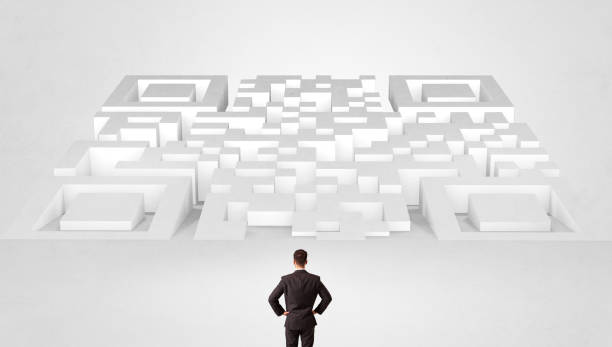 istock Small man standing in front of a huge maze 1202242613