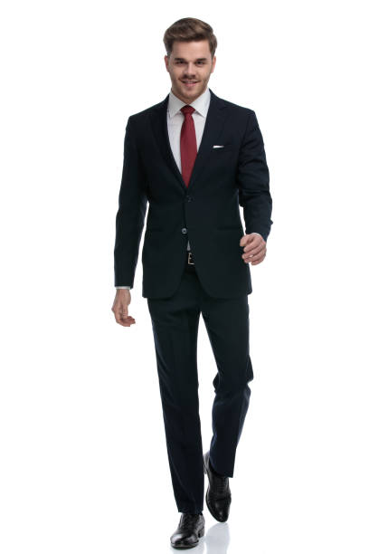 istock confident young businessman in suit smiling and walking 1202242755