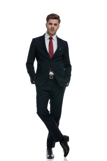 istock confident young businessman in suit holding hands in pockets 1202242834