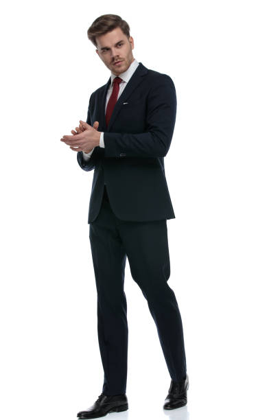 istock young businessman rubbing palms and looking to side 1202242958