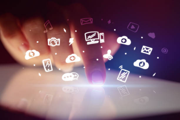 istock Finger touching tablet with white app icons above 1202243134
