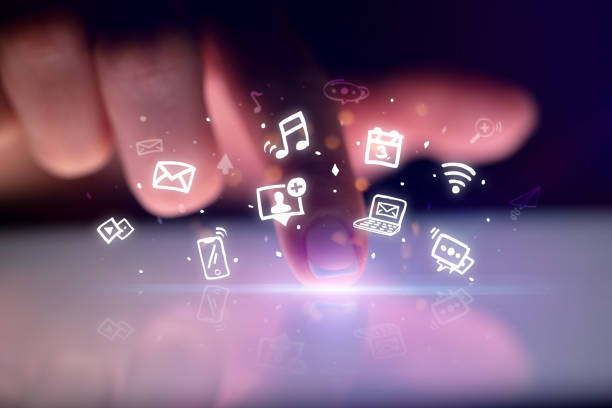 istock Finger touching tablet with hologram app icons above 1202243201