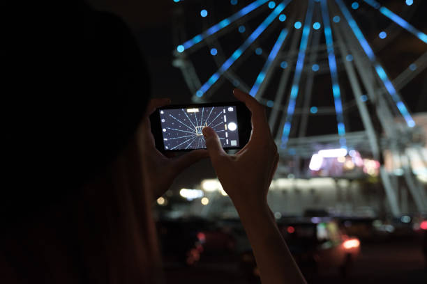 istock Photographing Ferris wheel on smart phone 1202244010