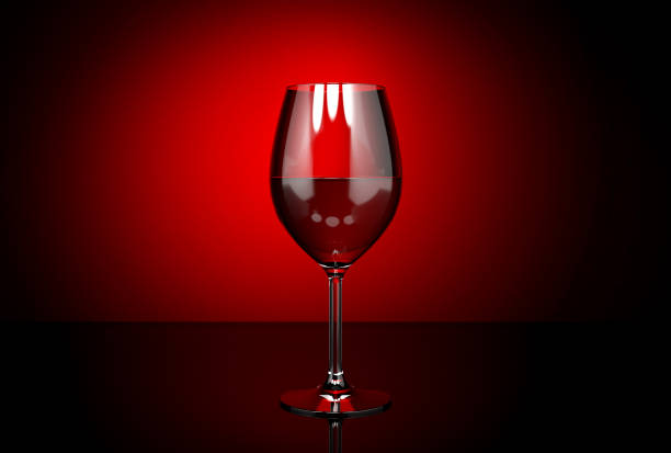 istock Wine glass with red wine. On dark red background 1202244504