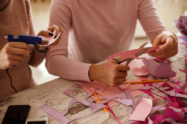 istock Girlfriends working in a team on making paper flowers 1202246592