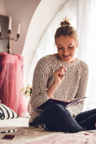 istock Confidant young woman smiling while studying for a test 1202246888