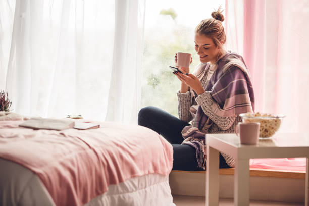 istock Woman smiling after reading a text message on her smart phone 1202247134