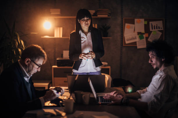 istock Three colleagues working late at night in office together 1202247306