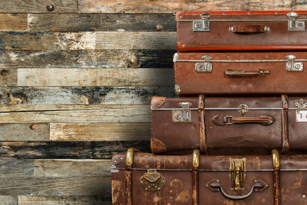 istock Old suitcases on wooden background 1202247998