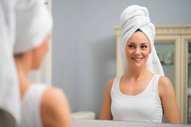 istock Happy woman looking at her skin 1202248437