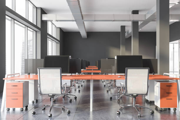 istock Gray industrial style office with orange tables 1202249269