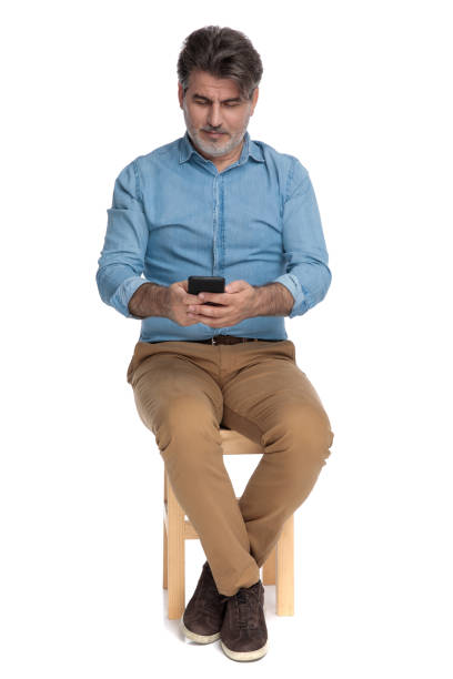 istock Positive casual man writing on his phone and smiling 1202249857
